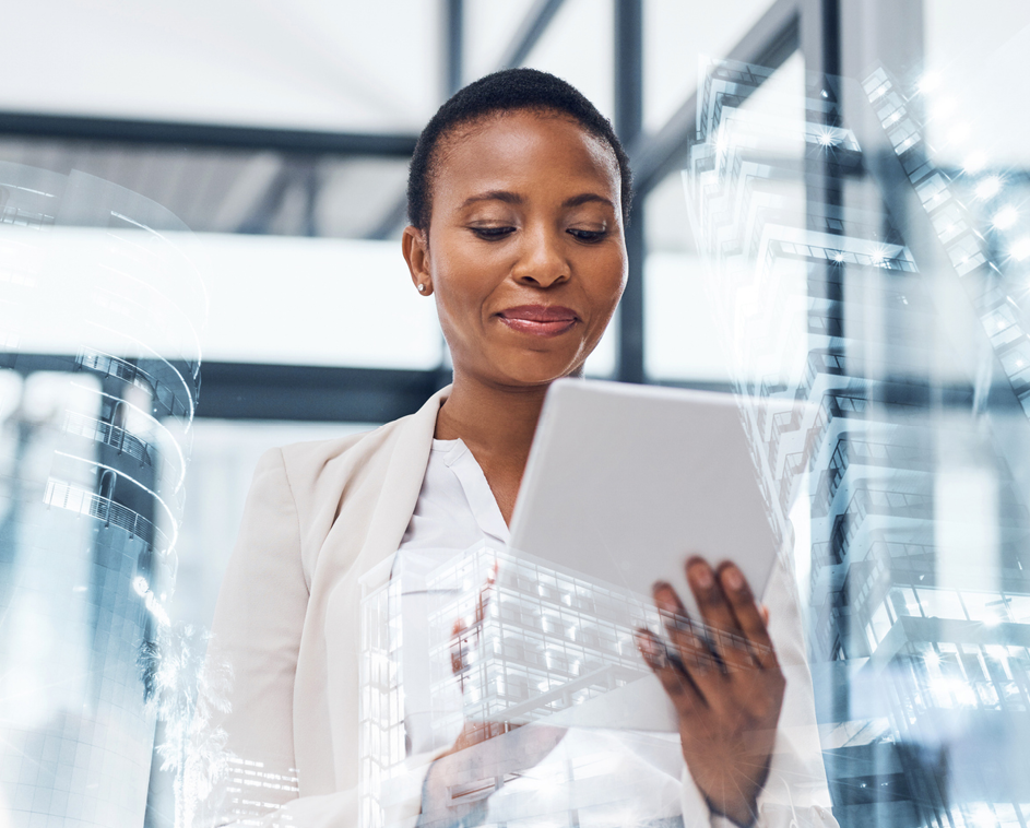 Businesswoman focused on her tablet in a sleek, modern office environment.